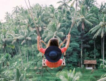 girl on swing in forest