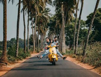 Couple riding scooter