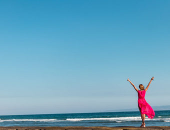 Girl on beach in pink dress