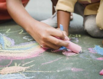 girls using sidewalk chalk