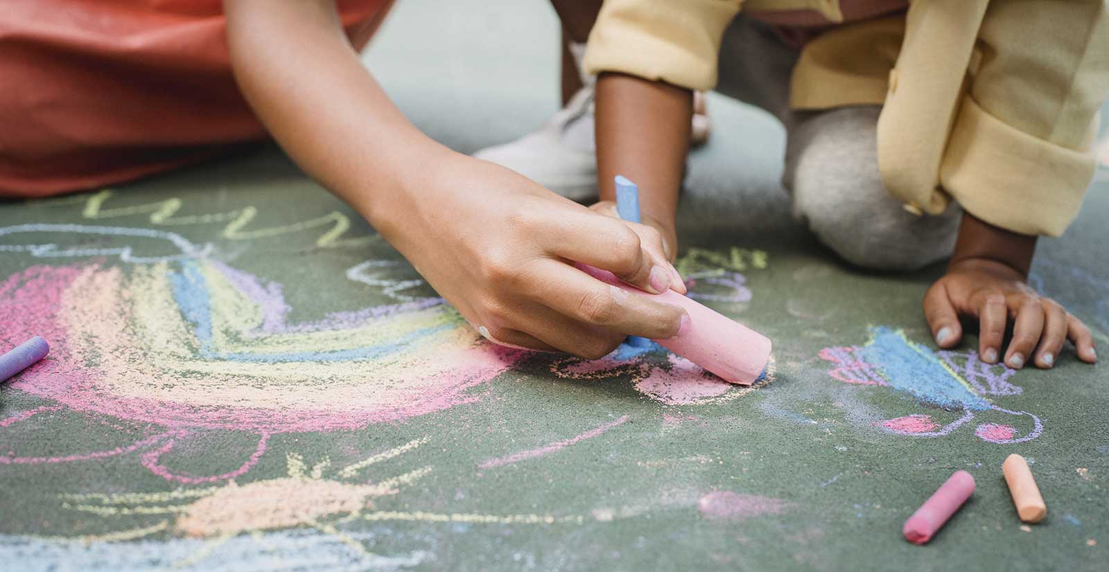 girls using sidewalk chalk
