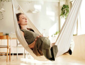 Woman relaxing in an indoor hammock