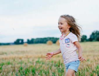young girl running in the grass