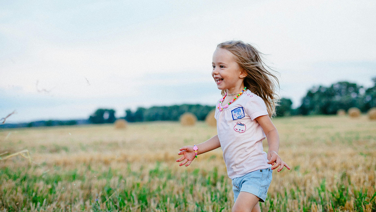 young girl running in the grass